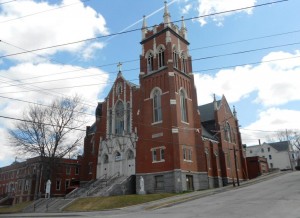 St. Louis Roman Catholic Church of New Auburn has been slated for demolition due to unsafe structural conditions. To the left of the church is the former convent for the Franciscan Sisters who formerly taught at St. Louis School. The white building behind the church is the former rectory for the parish’s priests. (Photo by Rachel Morin.)