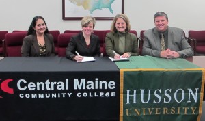 Representatives of Central Maine Community College and Husson University sign a major new agreement allowing students to more easily transfer credits between the two schools.